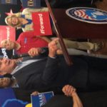 Man speaking at a political event podium.